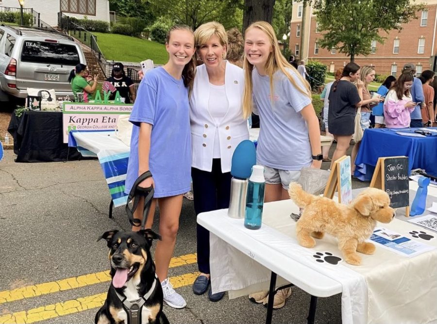 (Left to right) Blakely Queen, Cathy Cox and Lillian McGilliard in front of the GC Shelter Buddies table at this years block party